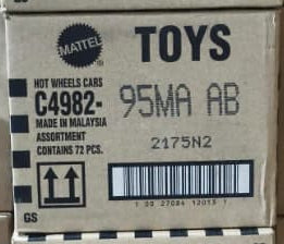 Stacks of cardboard boxes labeled 'TOYS' in a warehouse setting.