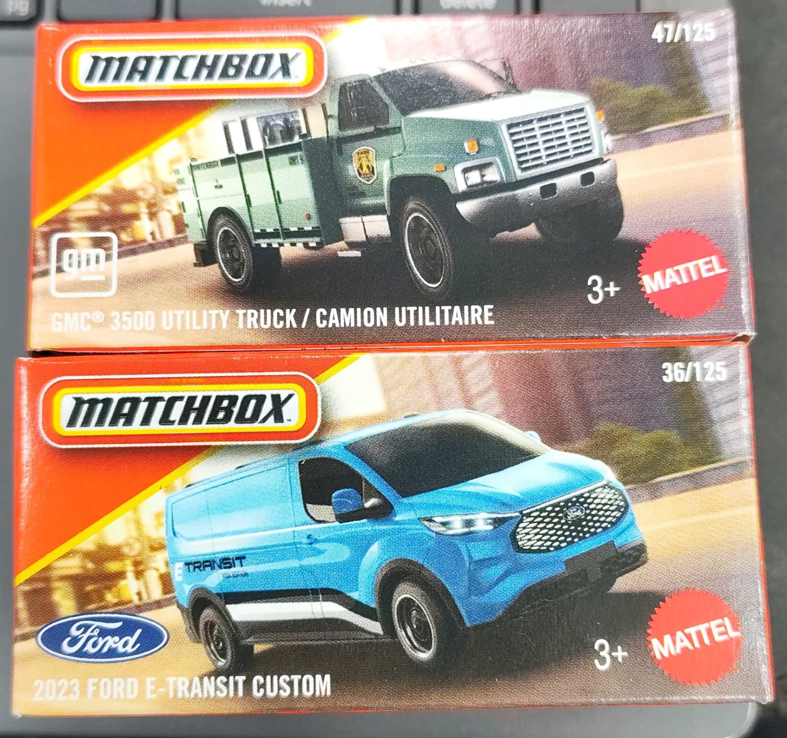 Matchbox Mainline - Combo Pack of 2 Cars - GMC 3500 Utility Truck/ Camion Ulilitaire & 2023 Ford E-Transit Custom - DNK70